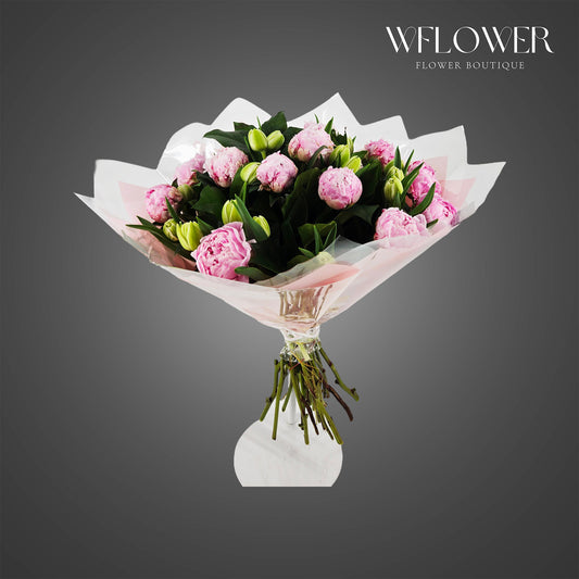 Blush pink peony and lily bouquet wrapped in luxury floral paper