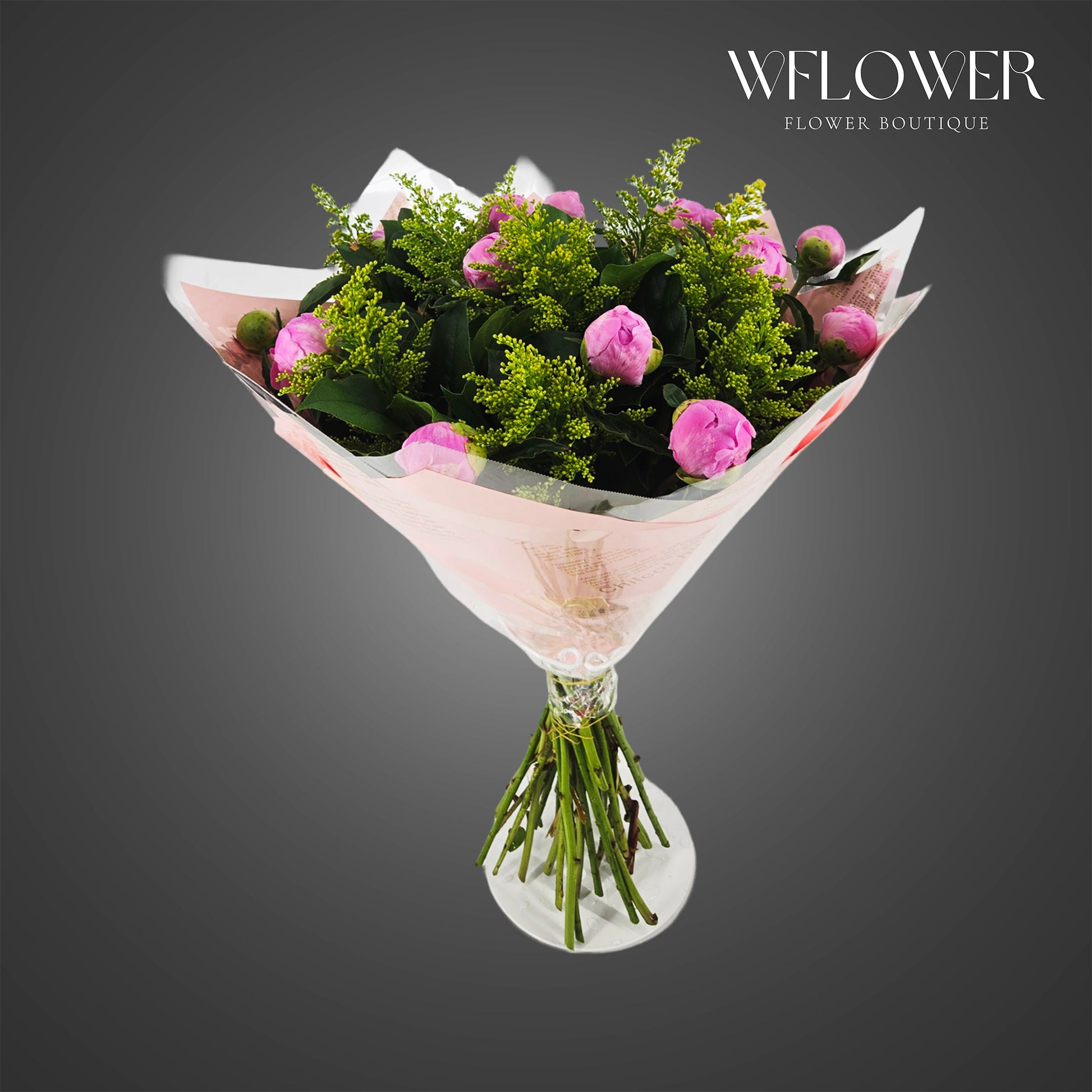 Pink peony and solidago bouquet wrapped in blush floral paper